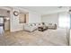 Open concept living room with tile floors and large sectional couch at 6409 Shawnee Springs Ct, Las Vegas, NV 89139