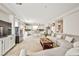 Bright open concept living room and kitchen with tile floors and large gray sectional at 6409 Shawnee Springs Ct, Las Vegas, NV 89139