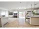 Open concept living room and kitchen with tile floors and sliding glass doors at 6409 Shawnee Springs Ct, Las Vegas, NV 89139