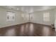 Bright, open-concept living room with hardwood floors and large windows at 6485 Arrow Cottage Ct, Las Vegas, NV 89130