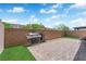 Backyard featuring a stone patio, grill and a patch of grass at 6626 Seahorse Reef St, Las Vegas, NV 89149