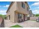 An inviting backyard patio features brick pavers, comfortable seating, and a manicured lawn, perfect for outdoor relaxation at 6626 Seahorse Reef St, Las Vegas, NV 89149