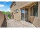 Private backyard patio area features brick pavers and access to the home via a sliding glass door at 6626 Seahorse Reef St, Las Vegas, NV 89149