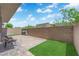 Backyard featuring a stone patio, grill and a patch of grass at 6626 Seahorse Reef St, Las Vegas, NV 89149