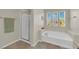 Bathroom featuring separate shower and large soaking tub with natural light at 6626 Seahorse Reef St, Las Vegas, NV 89149