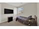 Bedroom featuring a bed, a mounted TV, and a window offering natural light at 6626 Seahorse Reef St, Las Vegas, NV 89149