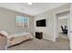 Bedroom featuring a bed, a mounted TV, and a window offering natural light at 6626 Seahorse Reef St, Las Vegas, NV 89149