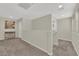 Hallway with carpet, neutral walls, and simple decor at 6626 Seahorse Reef St, Las Vegas, NV 89149