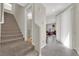 Hallway with staircase leading to the upper level with access to the living room and bathroom at 6626 Seahorse Reef St, Las Vegas, NV 89149