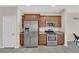Kitchen featuring stainless steel appliances, light wood cabinets, granite countertops, and a door to the outside at 6626 Seahorse Reef St, Las Vegas, NV 89149