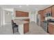 Spacious kitchen featuring stainless steel appliances, wooden cabinets, a granite countertop, and an island with barstool seating at 6626 Seahorse Reef St, Las Vegas, NV 89149
