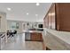Open-concept kitchen and living room area with stainless steel appliances, granite countertops, and a breakfast nook at 6626 Seahorse Reef St, Las Vegas, NV 89149