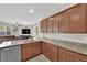 Kitchen featuring granite countertops, stainless steel appliances, and ample cabinet space overlooking the living room at 6626 Seahorse Reef St, Las Vegas, NV 89149