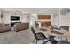 Open concept living space seamlessly connecting living, dining, and kitchen areas with tile floors and modern furniture at 6626 Seahorse Reef St, Las Vegas, NV 89149