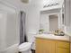 A bathroom with a shower and tub, a white toilet, and a sink and mirror at 6955 N Durango Dr # 3089, Las Vegas, NV 89149