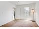 A bright bedroom with carpet and window and a door to another room at 6955 N Durango Dr # 3089, Las Vegas, NV 89149