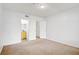 A bright bedroom with carpet and doors to a bathroom and closet at 6955 N Durango Dr # 3089, Las Vegas, NV 89149
