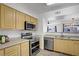 Well-equipped kitchen showcasing stainless steel appliances, light cabinetry and countertops at 6955 N Durango Dr # 3089, Las Vegas, NV 89149