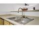 Well-lit kitchen featuring a stainless steel sink and faucet, with neutral countertops at 6955 N Durango Dr # 3089, Las Vegas, NV 89149