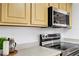 Modern stainless steel oven and microwave appliances complement the neutral kitchen decor at 6955 N Durango Dr # 3089, Las Vegas, NV 89149