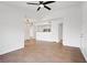 Open living room featuring tiled floors, neutral walls, ceiling fan and access to kitchen at 6955 N Durango Dr # 3089, Las Vegas, NV 89149