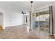 Well-lit living area with tiled floors, ceiling fan, and sliding glass door to private patio at 6955 N Durango Dr # 3089, Las Vegas, NV 89149