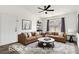 Inviting living room features neutral decor, ceiling fan, and large window with stylish curtains for a bright and airy space at 6955 N Durango Dr # 3089, Las Vegas, NV 89149