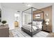 Tranquil main bedroom features a four poster bed, ensuite bathroom, and wood accent wall at 6955 N Durango Dr # 3089, Las Vegas, NV 89149