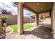 Inviting back patio featuring brick pavers, artificial grass, and a covered seating area at 7525 Campbell Ranch Ave, Las Vegas, NV 89179