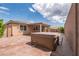 Hot tub in the backyard, along with the covered patio on a sunny day at 7525 Campbell Ranch Ave, Las Vegas, NV 89179