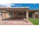 This backyard is complete with a covered patio and artificial turf area at 7525 Campbell Ranch Ave, Las Vegas, NV 89179
