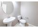 A simply designed bathroom features a modern sink and toilet against neutral-colored walls at 7525 Campbell Ranch Ave, Las Vegas, NV 89179