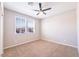A bedroom with neutral walls, carpet flooring, and a ceiling fan at 7525 Campbell Ranch Ave, Las Vegas, NV 89179