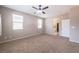 Bedroom featuring neutral colored walls, carpet flooring, a ceiling fan, and ensuite bathroom and closet at 7525 Campbell Ranch Ave, Las Vegas, NV 89179
