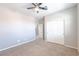 This bedroom features plush carpeting, a ceiling fan, and a spacious closet at 7525 Campbell Ranch Ave, Las Vegas, NV 89179
