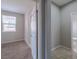 Hallway shot that showcases entry to bedroom with carpet, and bathroom with tile flooring and a doorway to the toilet at 7525 Campbell Ranch Ave, Las Vegas, NV 89179