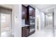 Stainless steel double oven and dark wood cabinets in the kitchen adds a modern touch at 7525 Campbell Ranch Ave, Las Vegas, NV 89179