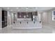 Beautiful kitchen featuring a large island, stainless steel appliances, and dark wood cabinets at 7525 Campbell Ranch Ave, Las Vegas, NV 89179