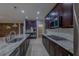 Modern kitchen featuring a granite-topped island, stainless appliances, and custom cabinetry at 7525 Campbell Ranch Ave, Las Vegas, NV 89179