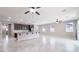 Bright open-plan kitchen and living area with lots of natural light and modern tile floors at 7525 Campbell Ranch Ave, Las Vegas, NV 89179