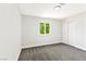 Empty bedroom featuring a light gray carpet, white walls, a bright window, and a closet at 811 Spyglass Ln, Las Vegas, NV 89107