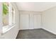 Bright bedroom featuring two closets and a window view of green foliage at 811 Spyglass Ln, Las Vegas, NV 89107