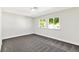 Empty bedroom with soft gray carpet, bright natural light from two windows, and neutral wall paint at 811 Spyglass Ln, Las Vegas, NV 89107