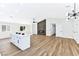 Open-concept living and kitchen area with hardwood floors, fireplace, and island at 811 Spyglass Ln, Las Vegas, NV 89107