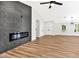 Spacious living room with wood-look floors and a contemporary fireplace with a gray accent wall at 811 Spyglass Ln, Las Vegas, NV 89107