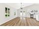 Bright, open living space with wood-look flooring, vaulted ceilings, modern lighting, and outdoor access at 811 Spyglass Ln, Las Vegas, NV 89107