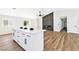 Open-concept living and kitchen area with hardwood floors, fireplace, and island at 811 Spyglass Ln, Las Vegas, NV 89107