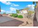 Gravel backyard with small bushes, patio, and block wall offers simple outdoor living at 82 Autumn Day St, Henderson, NV 89012