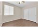 Bright bedroom featuring wood-look flooring, natural light, and a double door closet at 82 Autumn Day St, Henderson, NV 89012
