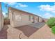 Tan home exterior showing patio, gravel, and block fence for a neutral backyard at 82 Autumn Day St, Henderson, NV 89012